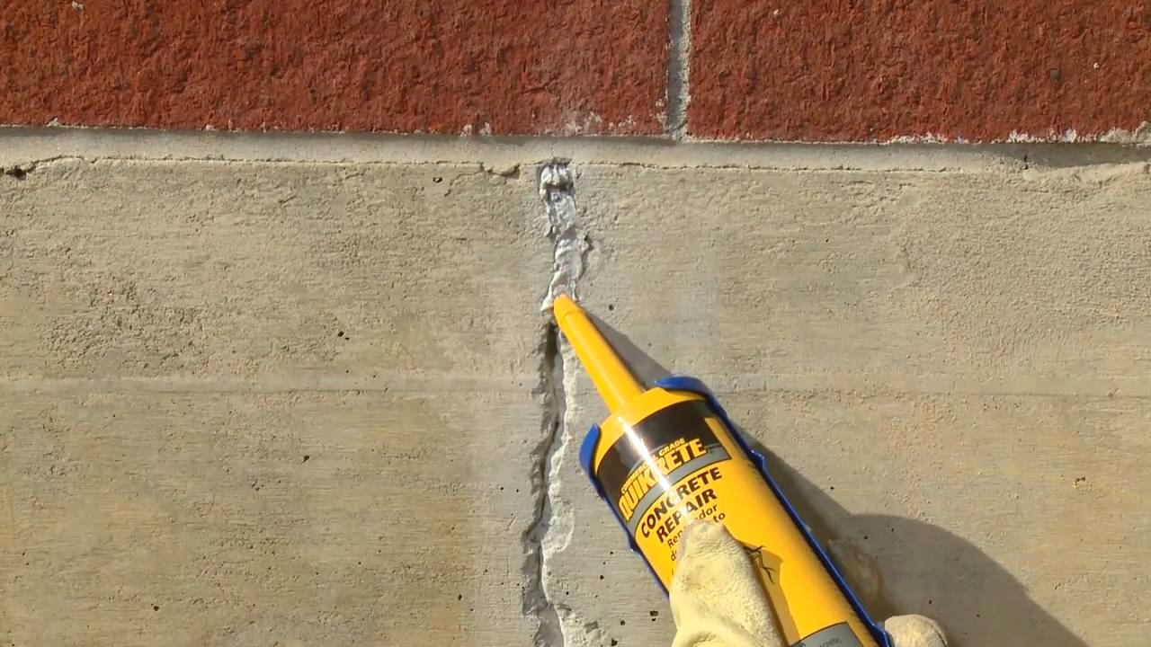 A basement concrete wall where an injected crack has been patched flush after the injection ports were removed