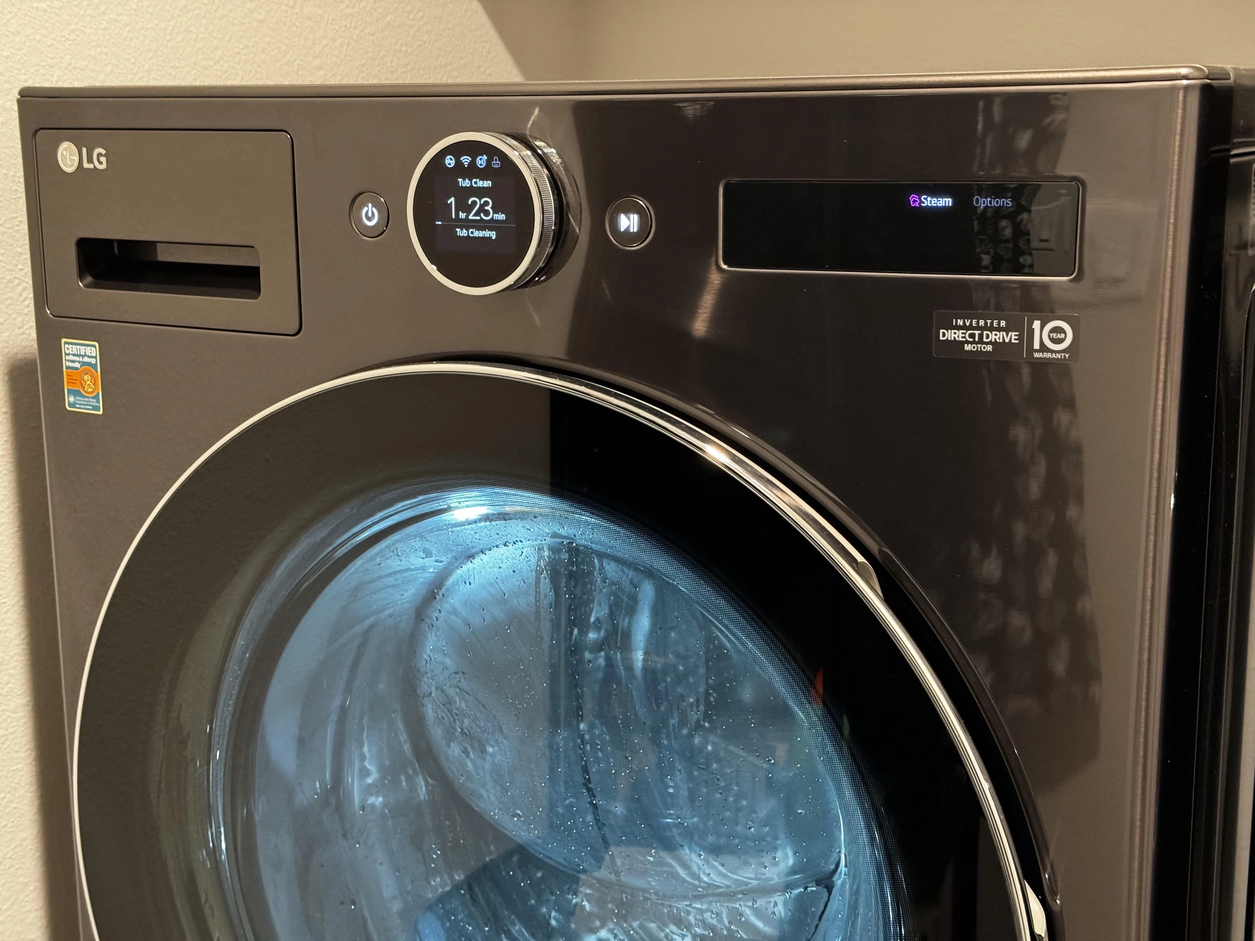 A front-load washer control panel with a tub clean or clean washer cycle selected