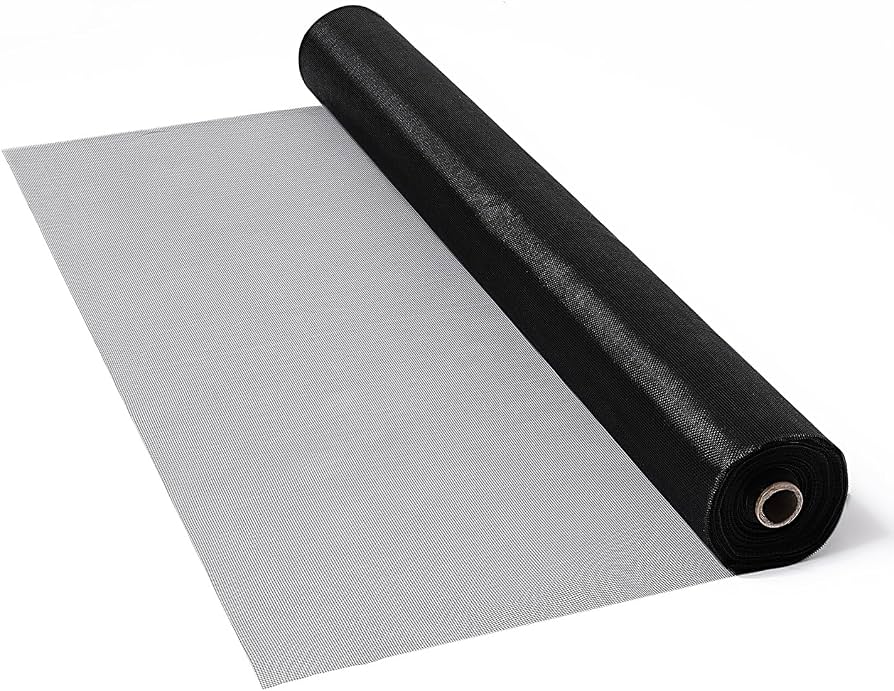 A roll of charcoal fiberglass window screen mesh partially unrolled on a flat work surface