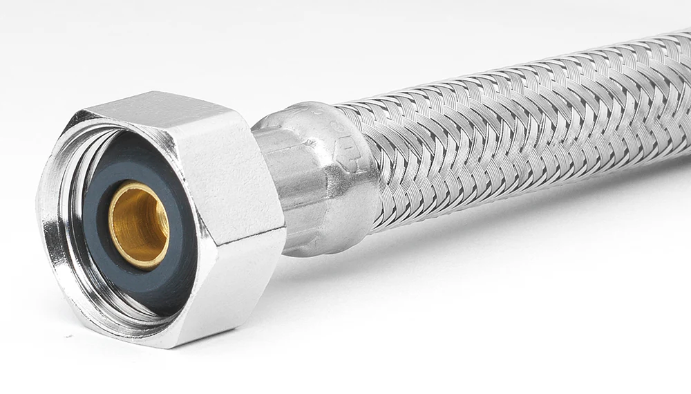 Under a sink, a braided stainless faucet supply line connects to a shutoff valve with a small droplet forming at the connection